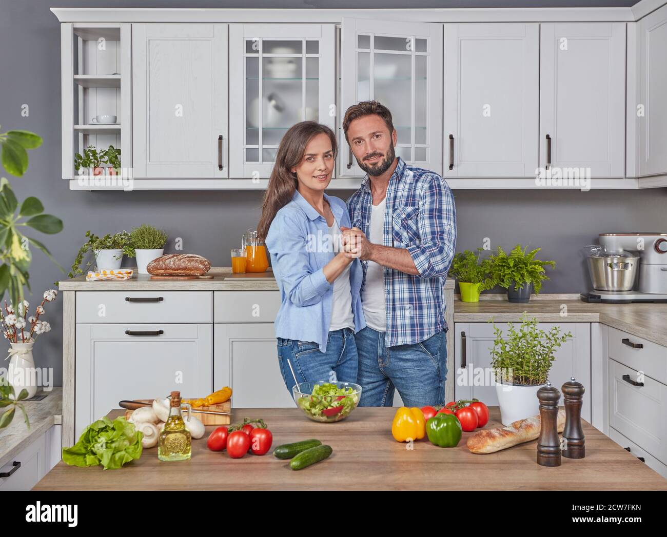 Happy couple dancing in the kitchen Stock Photo