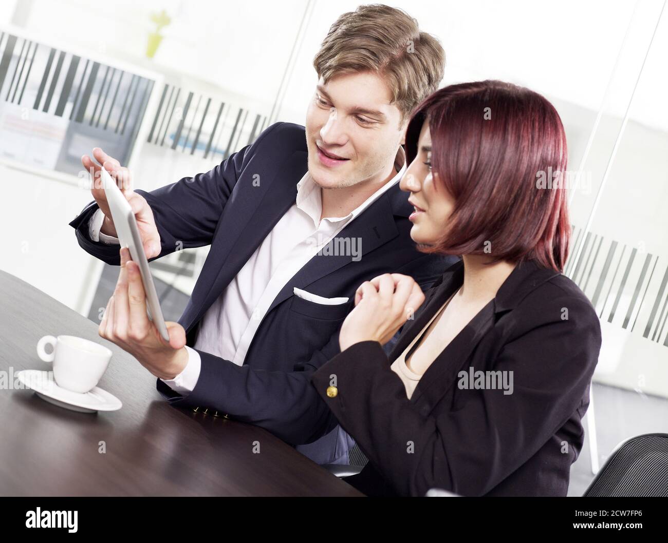 Co-workers looking at a digital tablet Stock Photo
