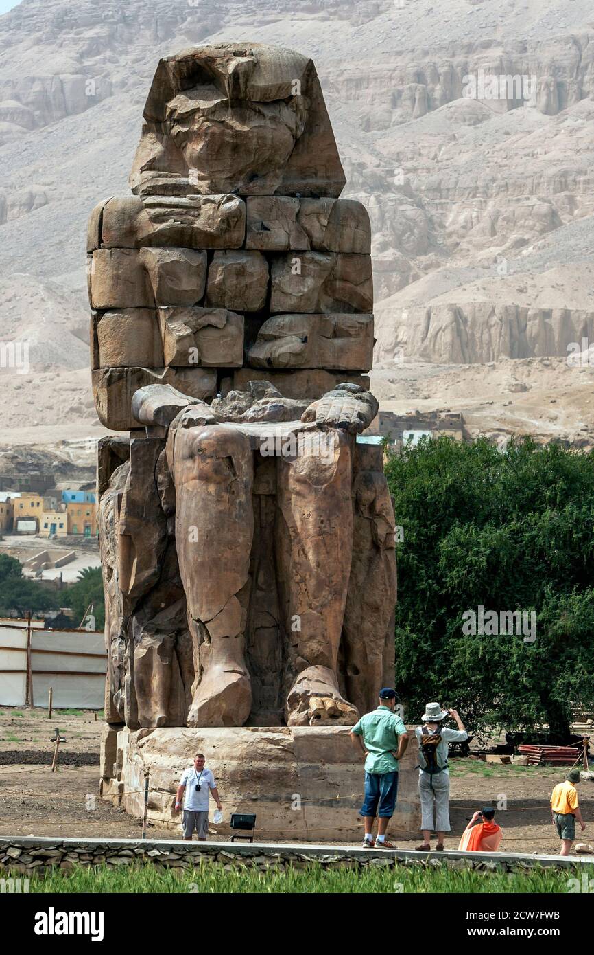 The remains of the southern colossus at the Colossi of Memnon at Luxor in Egypt. This is one of a pair of stone statues of Pharaoh Amenhotep III. Stock Photo