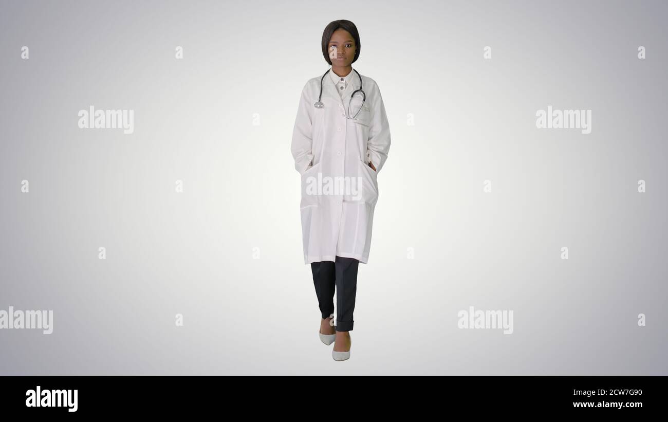 Sad African american female doctor walking with hands in her poc Stock Photo