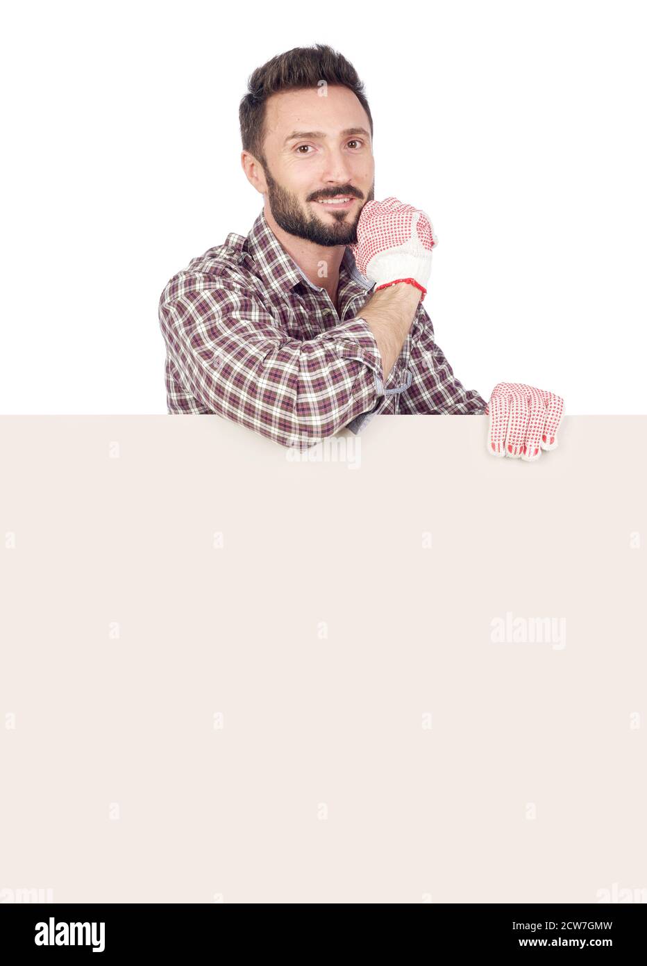 Cheerful handyman with blank board, white background Stock Photo