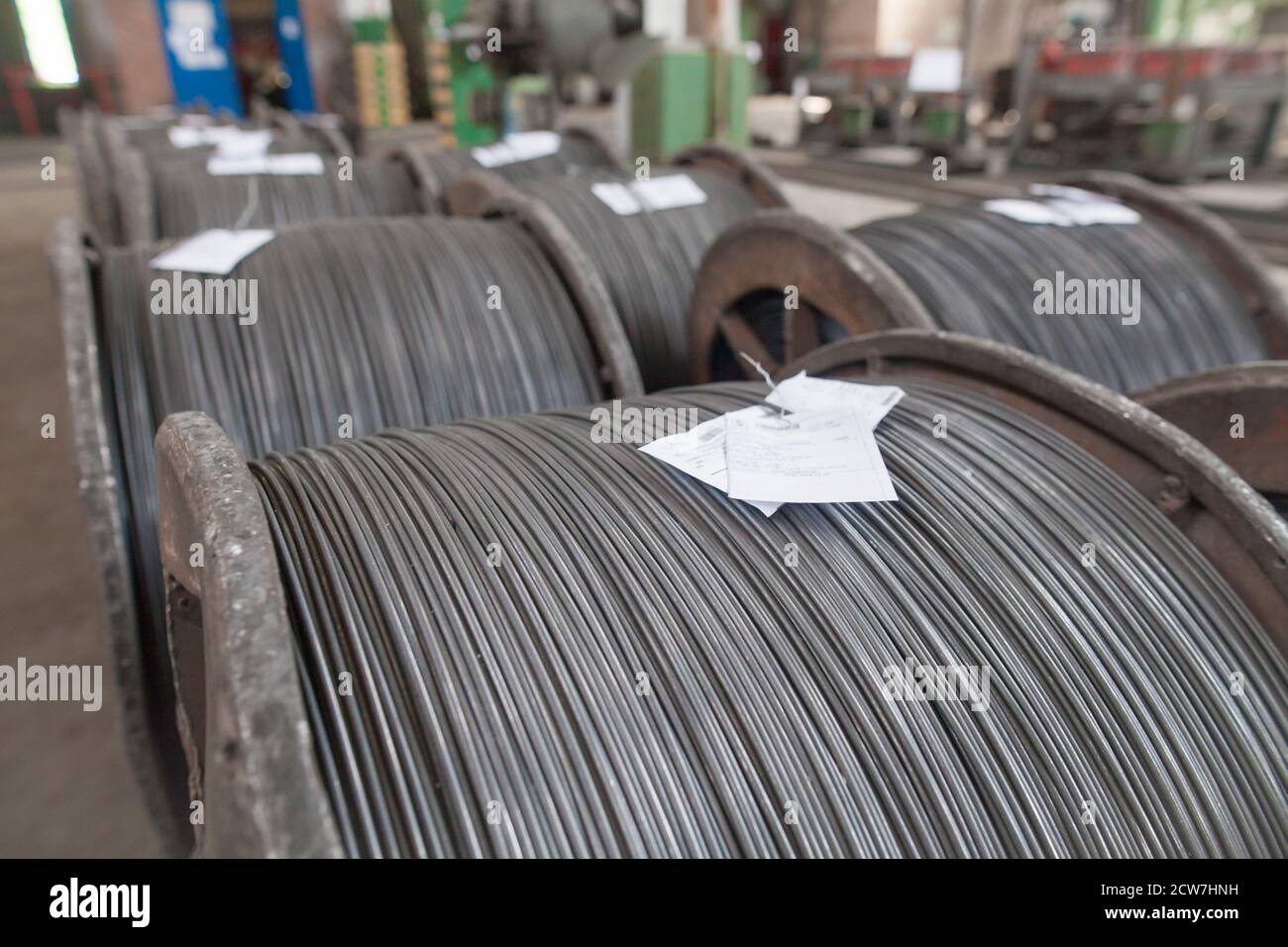 Wire rod, rebar, mesh in warehouses. production warehouse at the cable plant. Stock Photo
