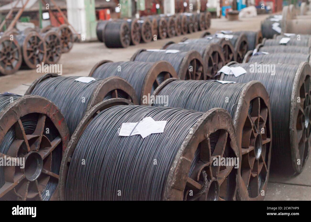 Wire rod, rebar, mesh in warehouses. production warehouse at the cable plant. Stock Photo