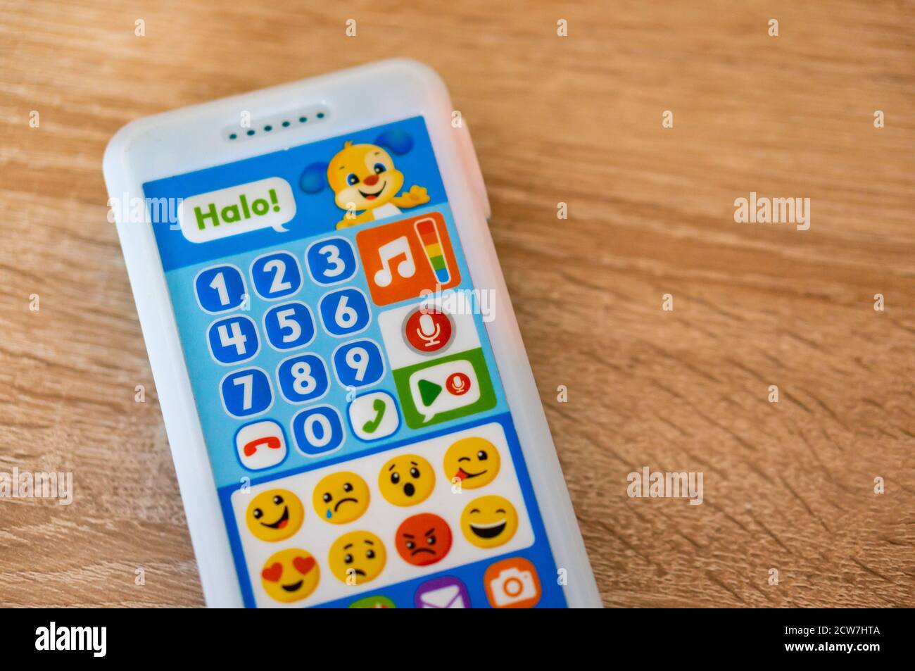 POZNAN, POLAND - Sep 12, 2020: Fisher Price toy telephone with many buttons on a wooden surface Stock Photo