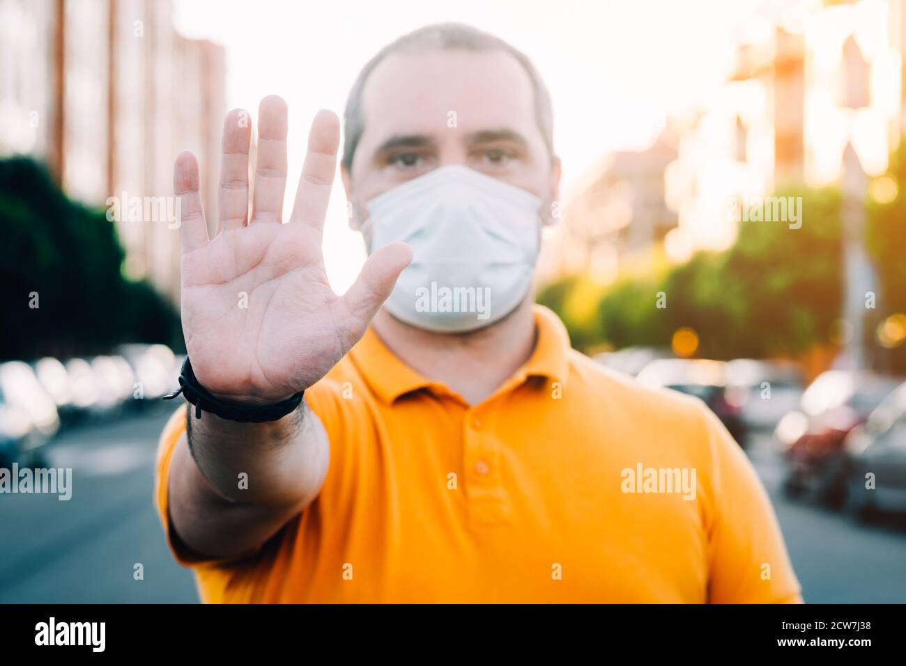 Man with a medicao mask gesturing stop Stock Photo