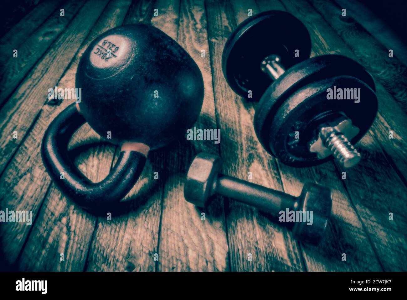heavy iron kettlebell on a rustic wood background - fitness concept,  soft focus with cyanotype toning  shot with lensless pinhole camera Stock Photo