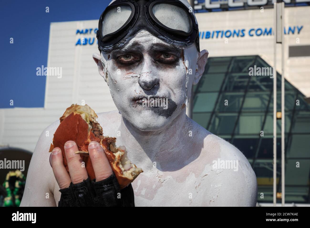 A cosplayers munches on his burger in full body paint at MCM Comicon