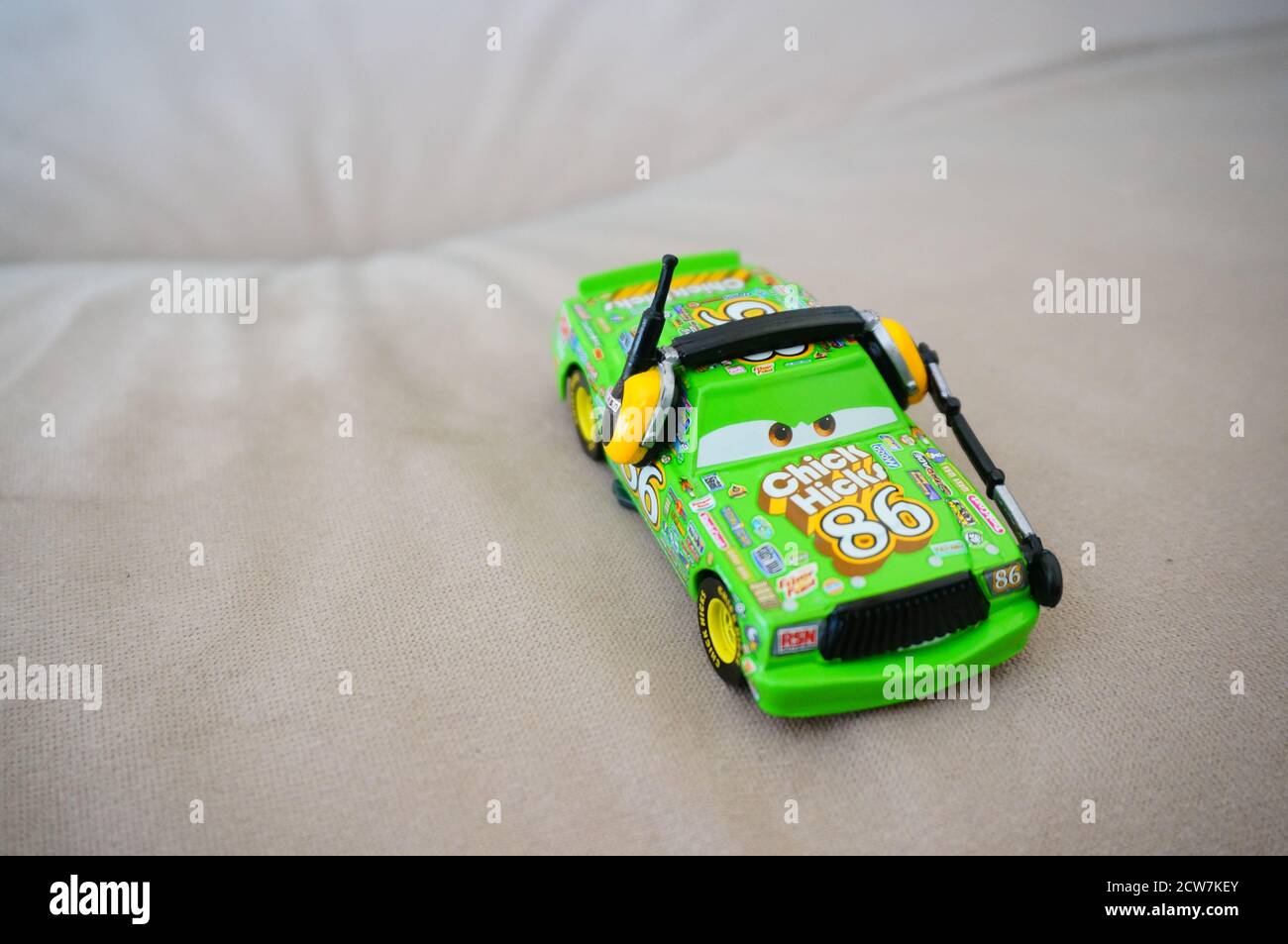 DEBINA, POLAND - Aug 01, 2020: Disney Pixar green toy Chick Hicks sport car with headphones and microphone. Stock Photo