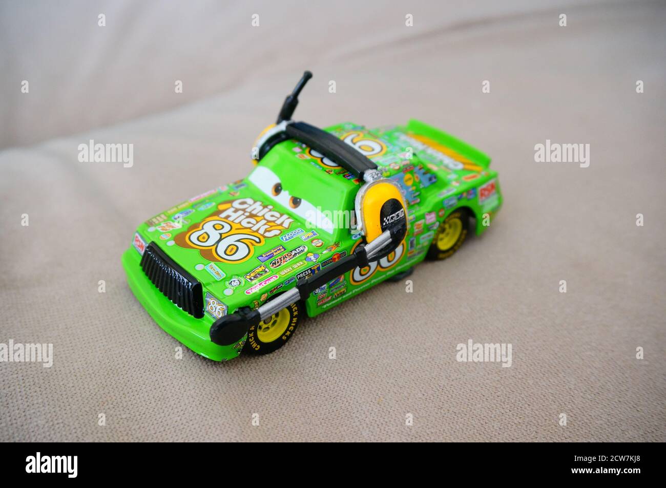 DEBINA, POLAND - Aug 01, 2020: Disney Pixar green toy Chick Hicks sport car with headphones and microphone. Stock Photo