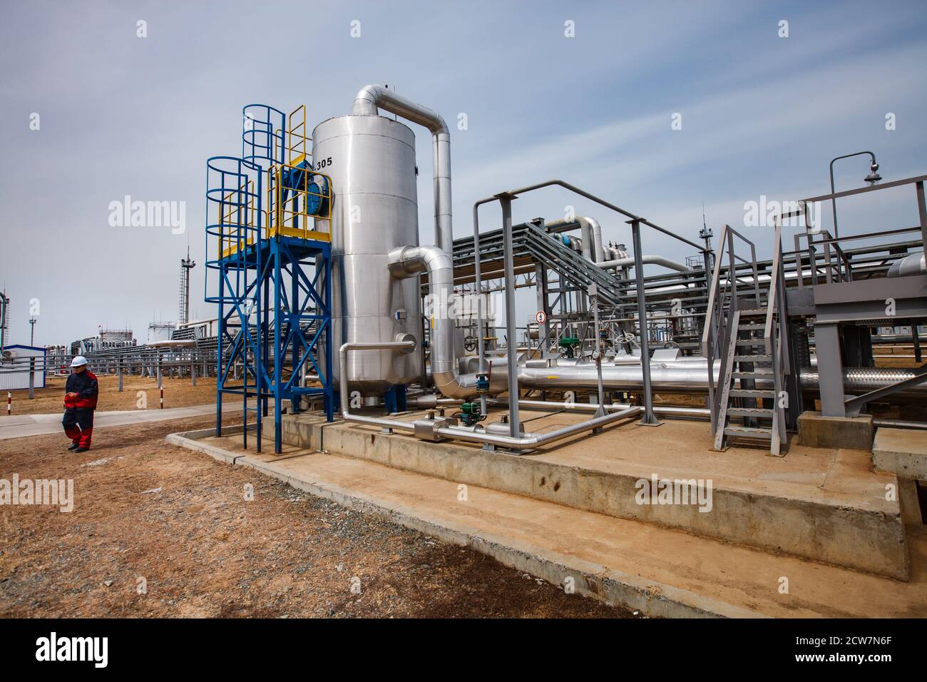 Refinery equipment, pipes, pipelines and worker or engineer. Oil