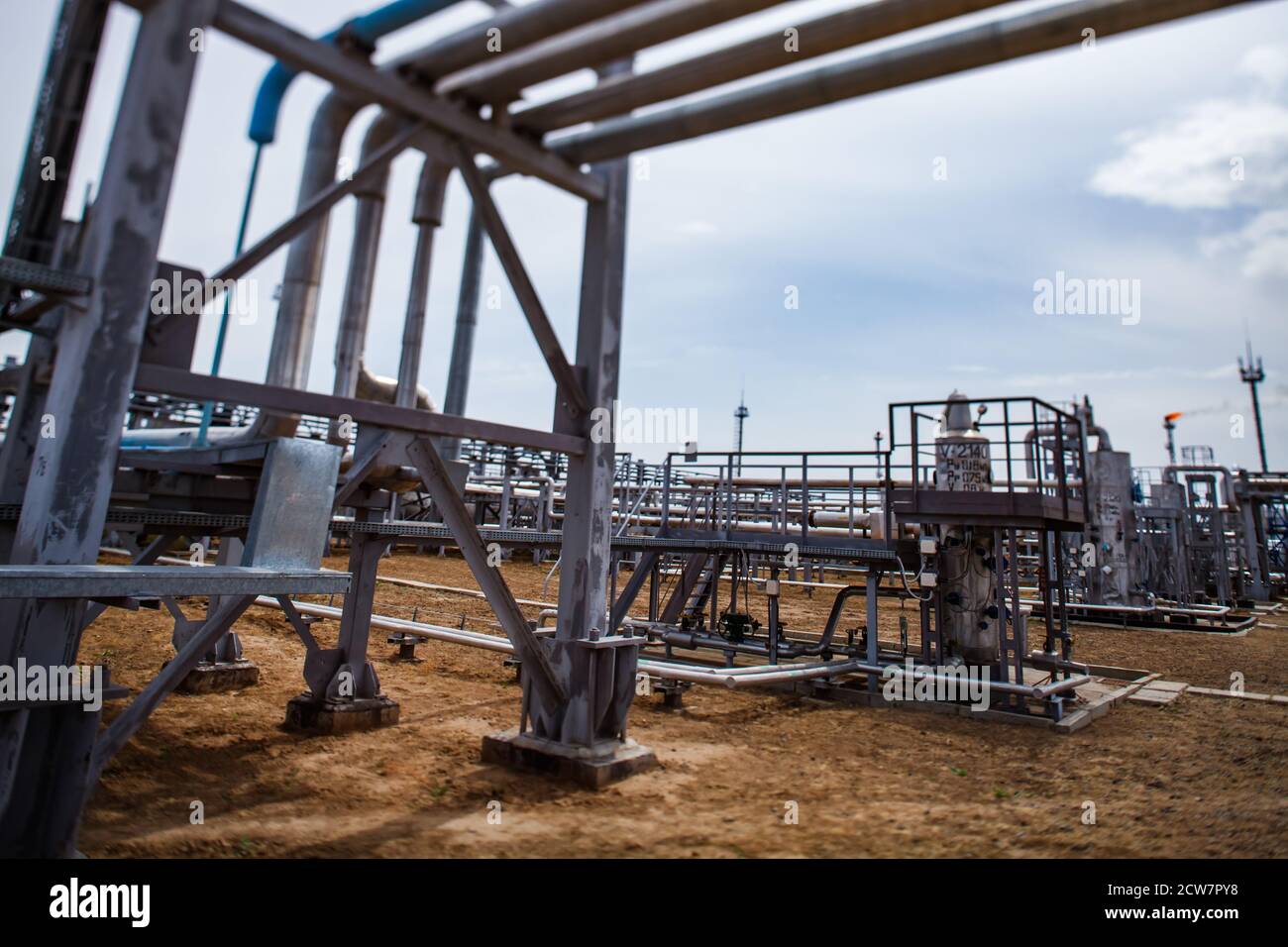 Oil refinery plant. Refinery pipelines and equipment. Tilt-shifted. Partially blurred photo. Zhaik-Munai oil deposit, Kazakhstan. Stock Photo