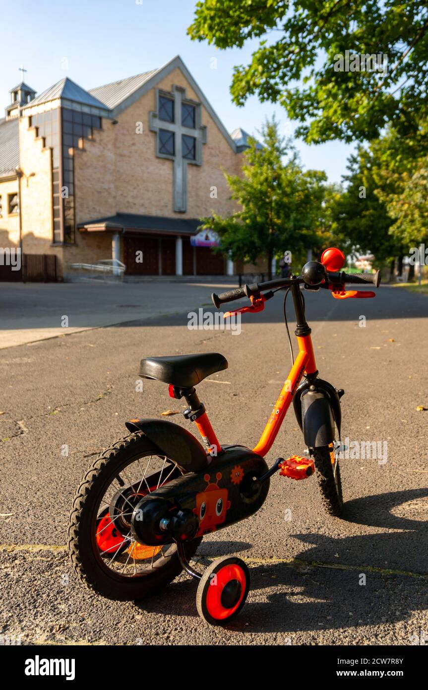 POZNAN, POLAND - Sep 15, 2020: Small Btwin Decathlon child bike with support  wheels on a street with church building Stock Photo - Alamy