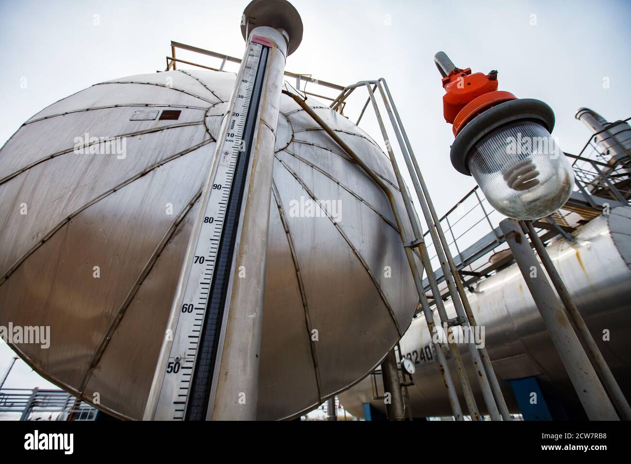 Close-up of petrochemical equipment. Oil refinery and gas processing plant. Explosion-proof lamp. Zhaik-Munai oil deposit, Kazakhstan. Stock Photo