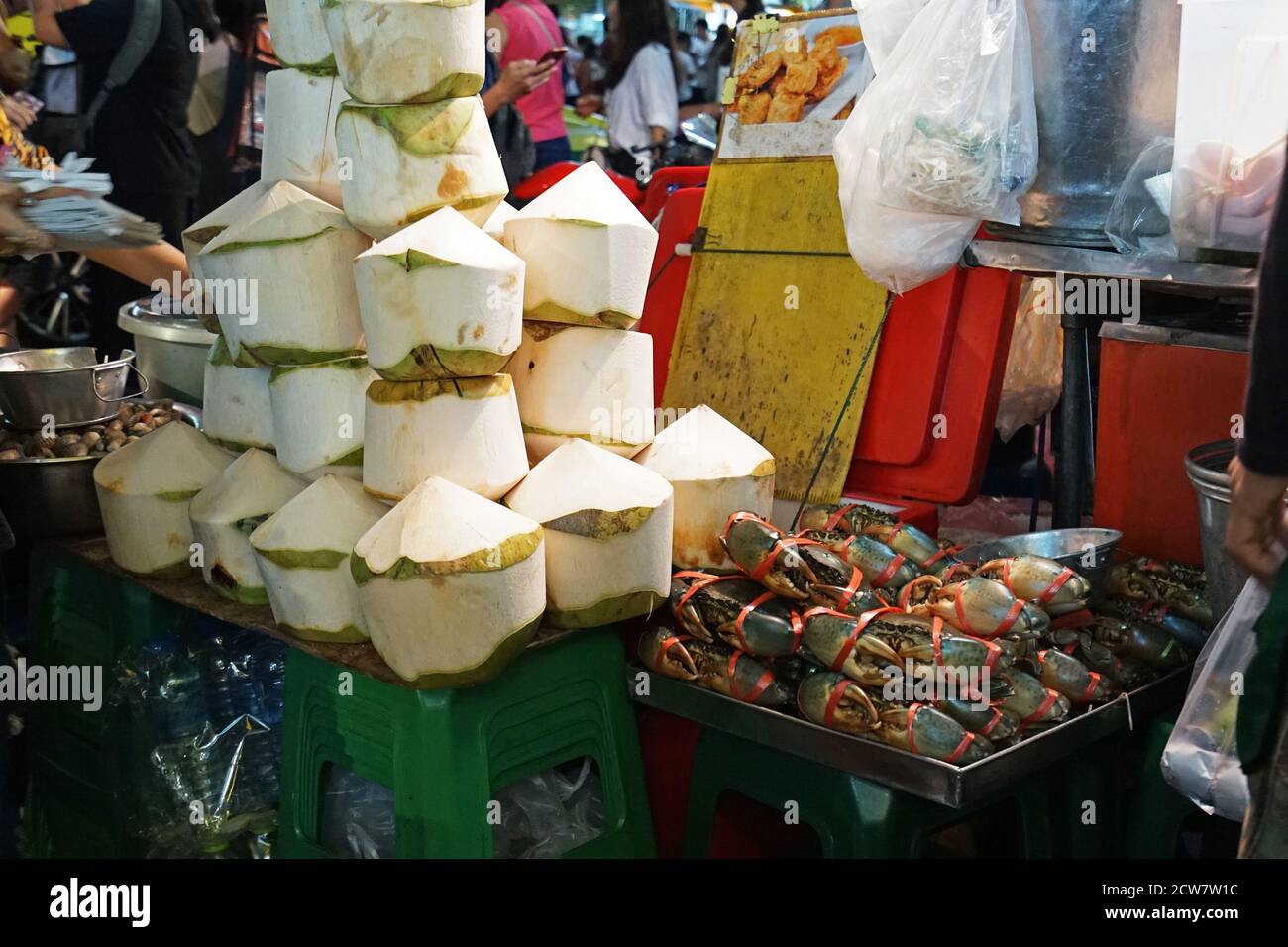 Display shelf of Fresh coconut with Sea crabs and Cockles at Bangkok