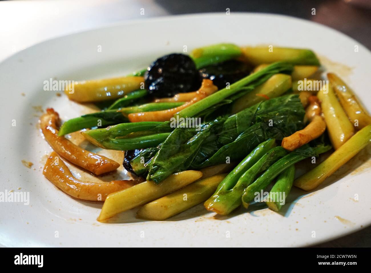 Close up Braised Abalone with Kale vegetable and Oyster Sauce Stock