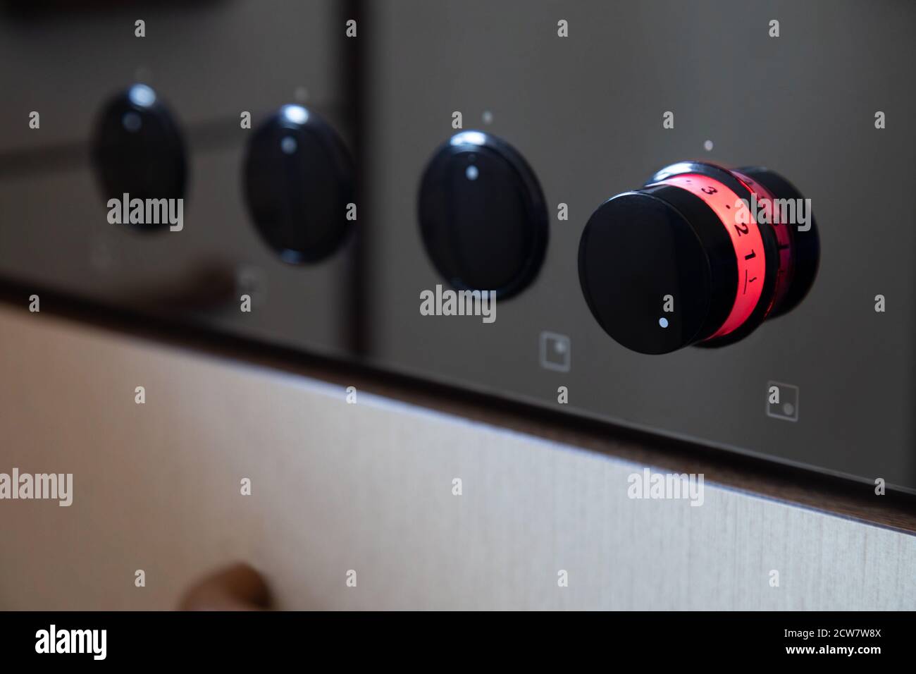 cooking stove, macro shot, rotary knob glows red and stands on level