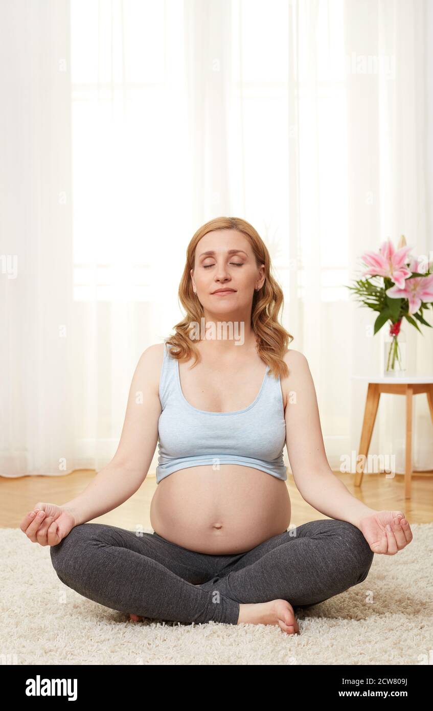 Young pregnant woman meditating Stock Photo