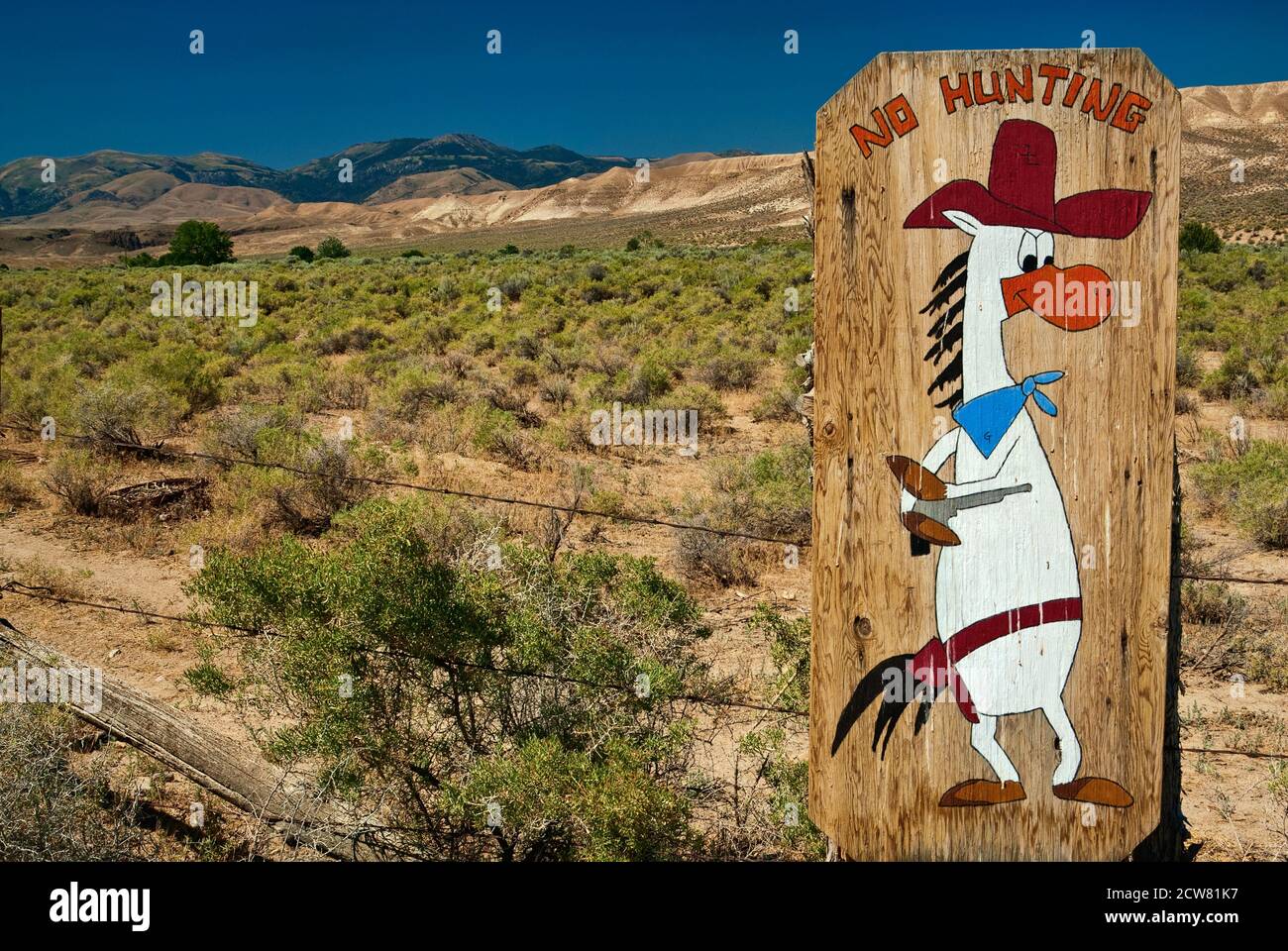 Humorous sign in shrubland at ranch in Owyhee Mountains, High Desert region, Idaho, USA Stock Photo