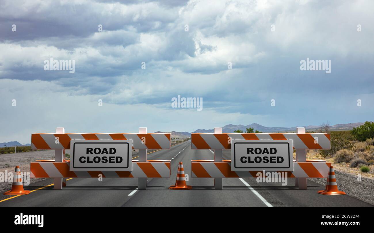 Closed road text sign, street barriers and traffic cones on empty highway, cloudy sky and USA countryside background. Construction safety, roadwork in Stock Photo