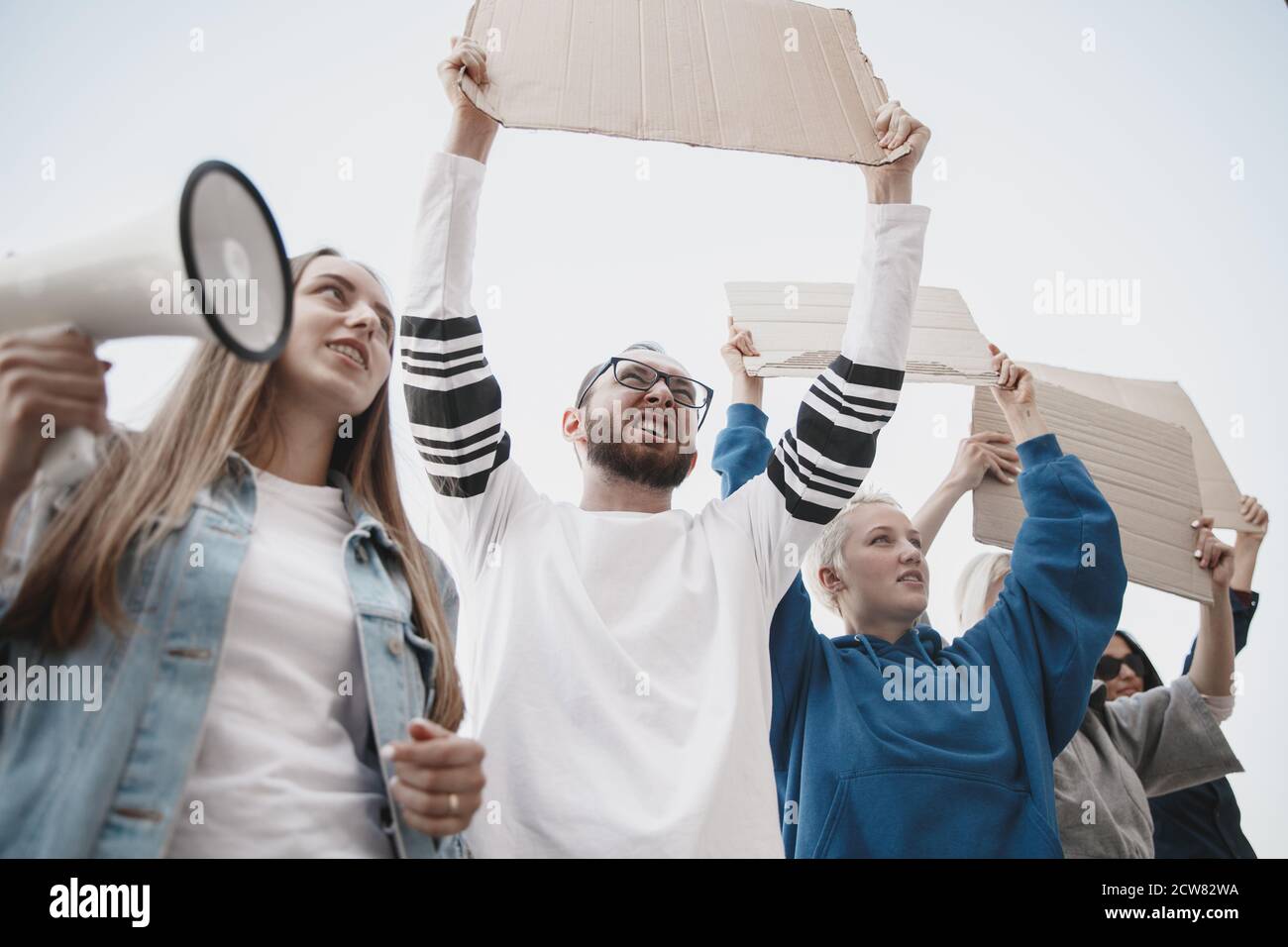 Fighting for more. Group of activists giving slogans in a rally ...