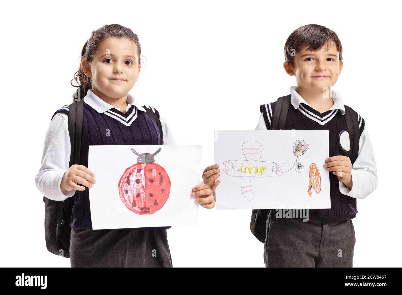 Full length portrait of a schoolchildren in uniforms holding drawings isolated on white background Stock Photo