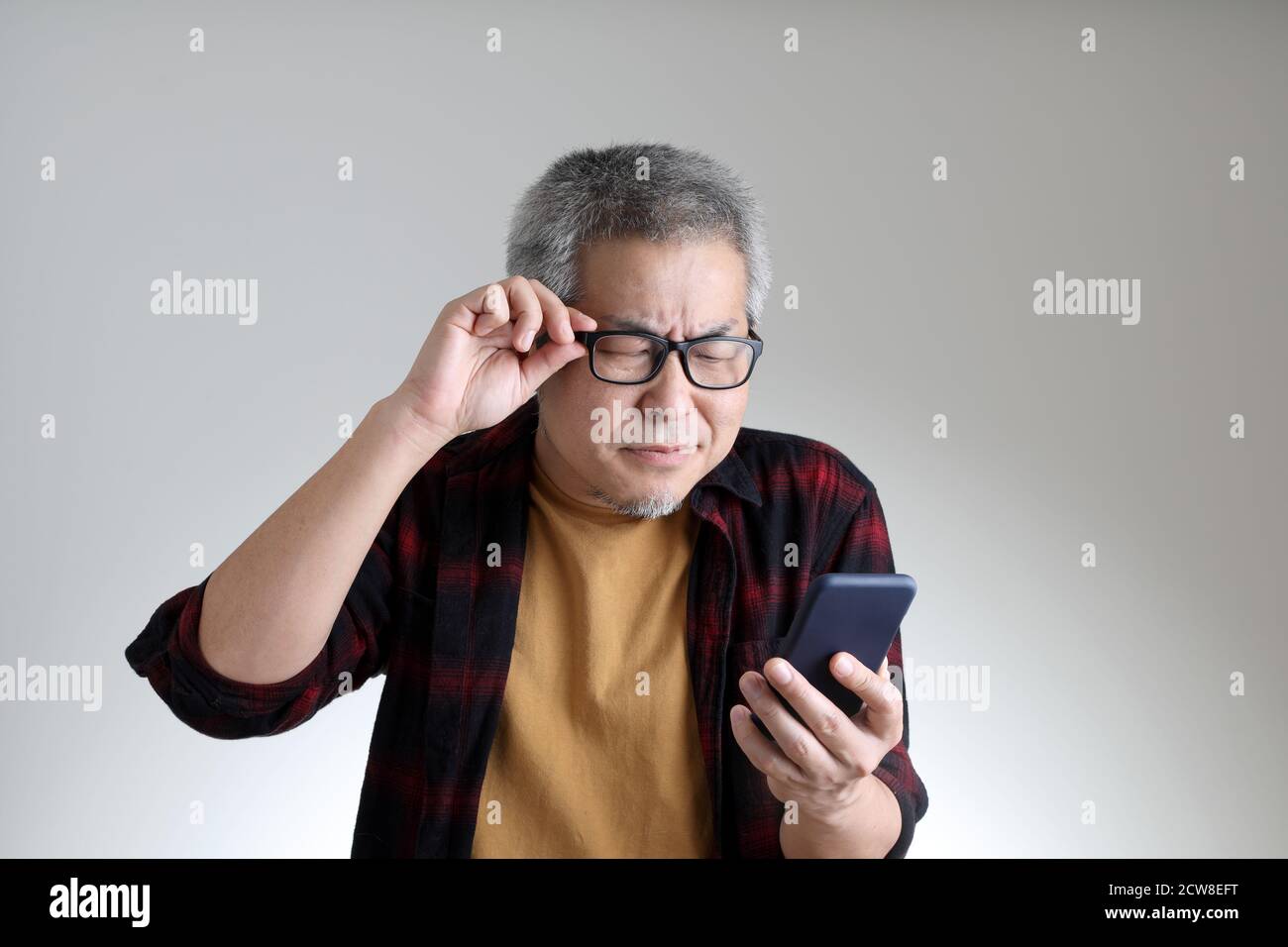 The Asian man standing on the white background. Stock Photo