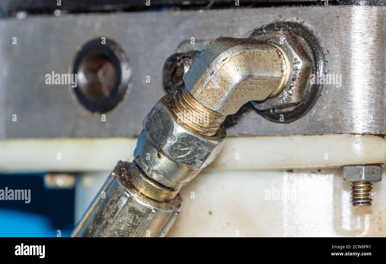 Close up shot of hydraulic pressure hose of a car lifting mechanism in