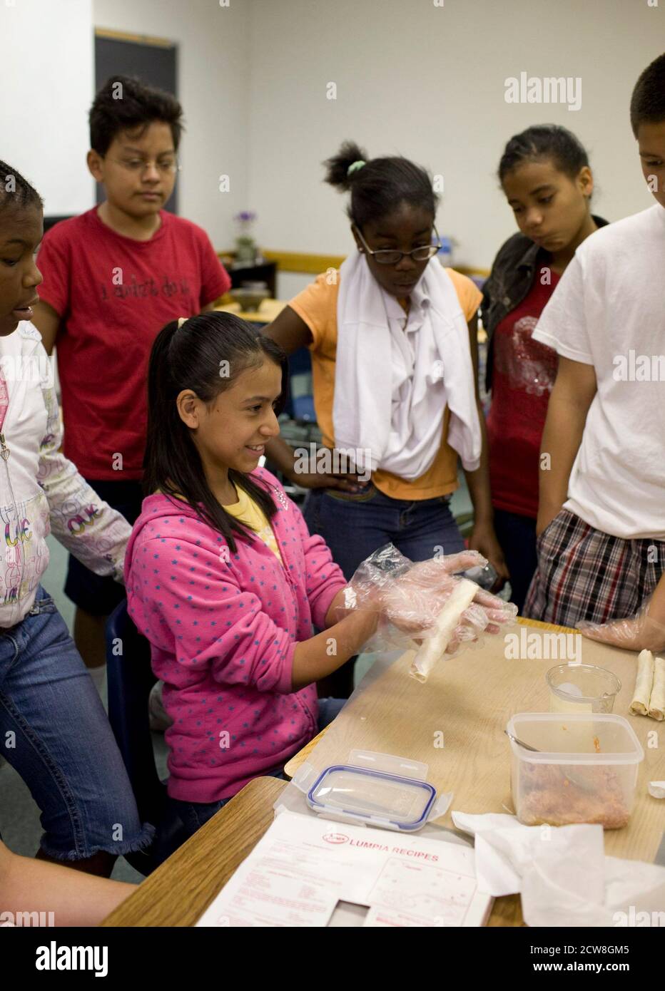 Pflugerville, TX  June 2, 2008: Students making Lumpia, a traditional food of the Phillipines during Park Crest Middle School's 'Diversity Day' with ethnic food, skits, poetry readings and music for sixth through eighth graders. ©Bob Daemmrich Stock Photo