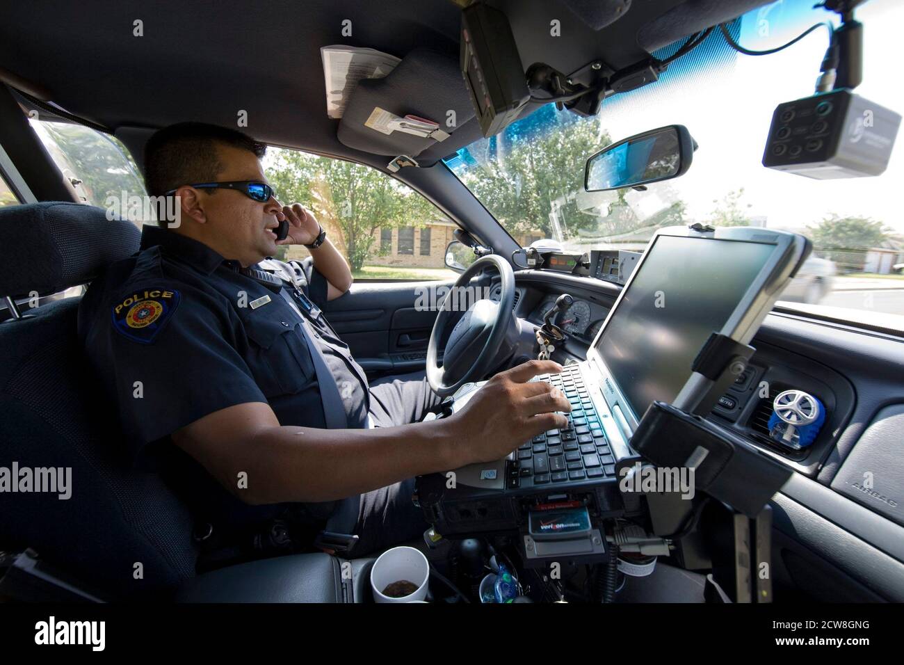 Round Rock, Texas:  July 20, 2008: Routine police work during the summertime work day in a north Austin suburb.  Police officer scans the license plates of cars while on routine patrol. ©Bob Daemmrich Stock Photo