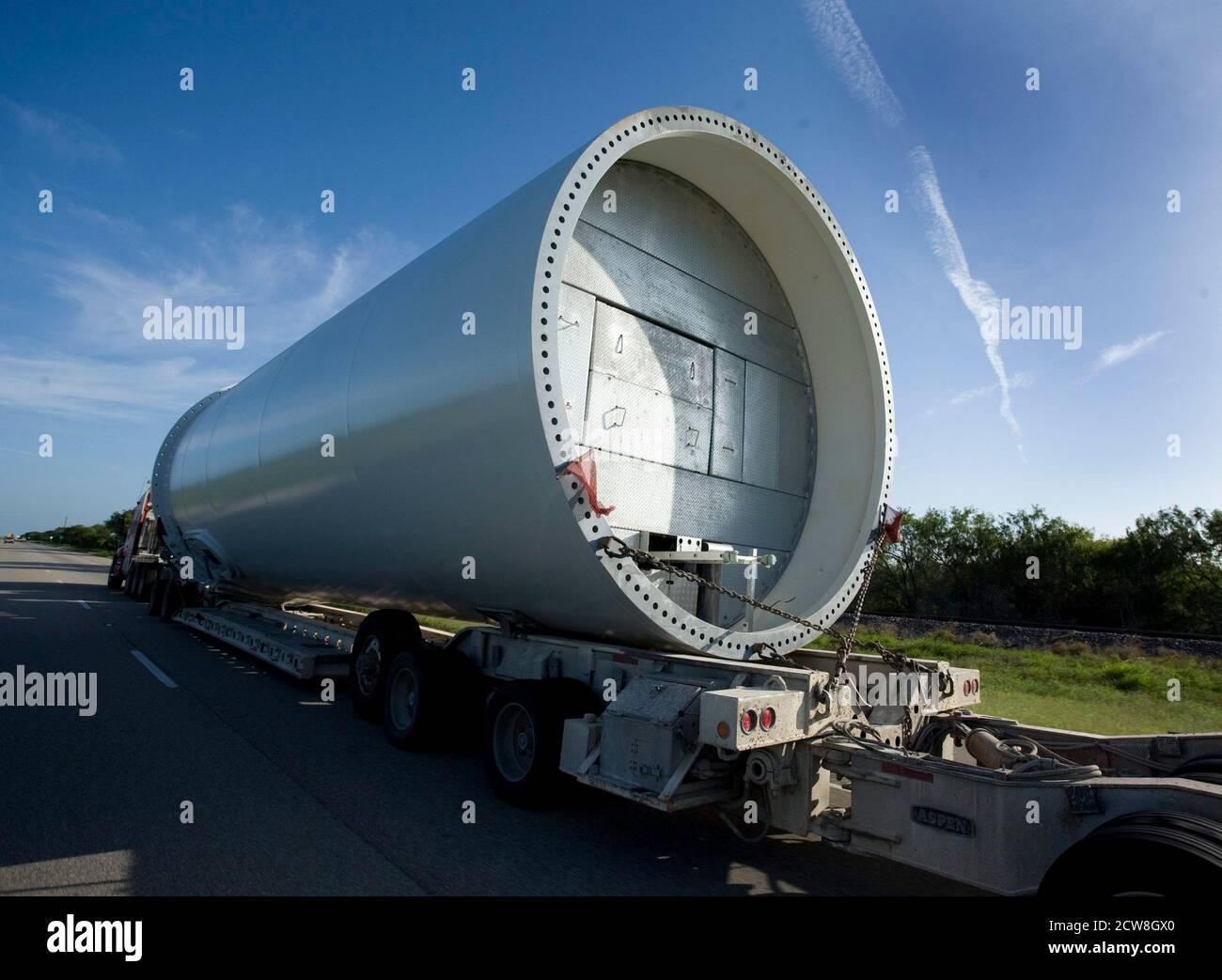 Rivera, TX. August 1, 2008: A steel support piece for a large wind turbine rides on the trailer of a truck on Highway 77 in south Texas. New wind turbine sites are springing up all over Texas. ©Bob Daemmrich Stock Photo