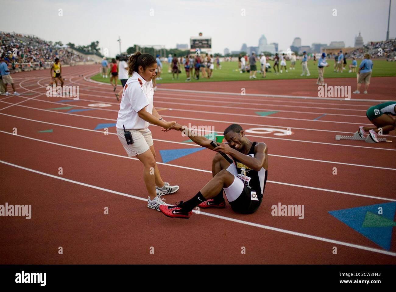 Austin Tx May 10 08 Female Trainer Helps Injured Black Runner To His Feet After Relay Race At The Texas High School State Championship Track And Field Meet At The University Of Austin Tx May 10 08 Female Trainer Helps Injured Black Runner To His Feet After Relay Race At The Texas High School State Championship Track And Field Meet At The University Of