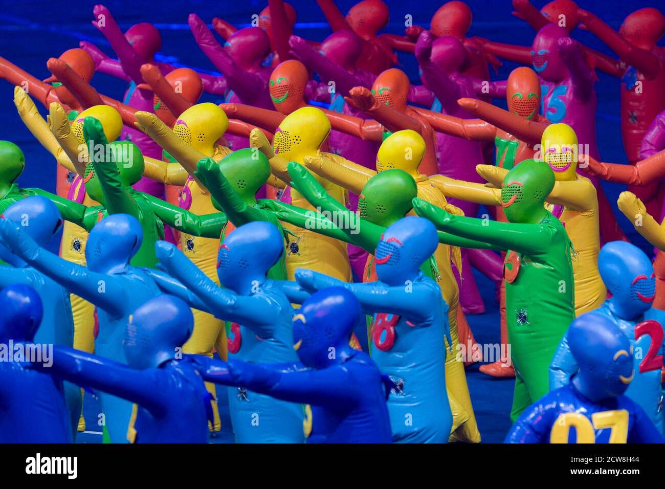 Beijing, China  September 6, 2008: Performers in multi-colored vinyl suits at the Opening Ceremonies of the Beijing Paralympics at China's National Stadium, known as the Bird's Nest. ©Bob Daemmrich Stock Photo