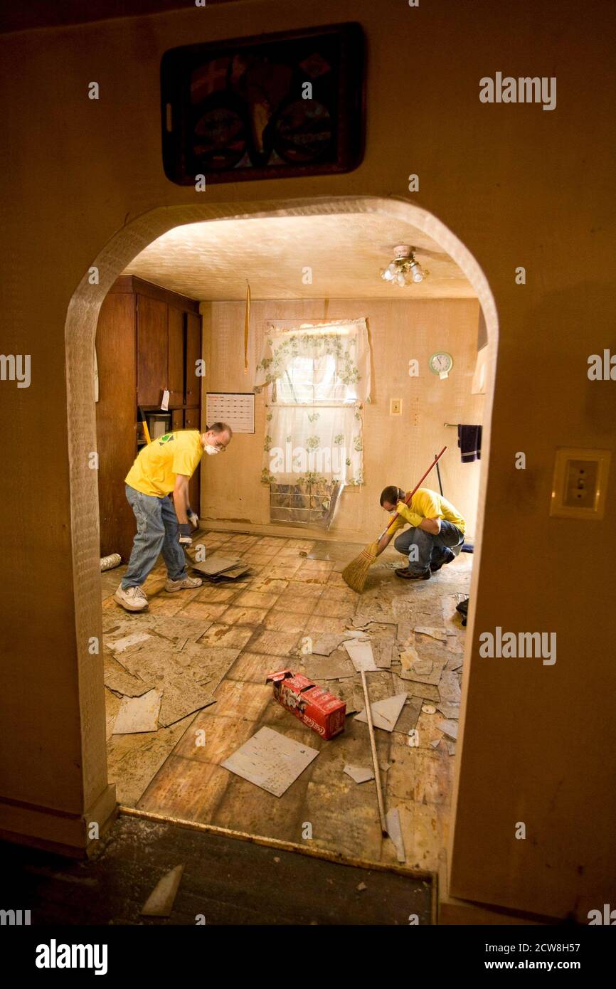 Galveston, TX September 27, 2008:  More than two weeks after Hurricane Ike ravaged Galveston Island and east Texas, some Galveston residents are still living in squalor conditions. Volunteers from the Mormon Church work on the house of Patricia Aguilar, 75, of 1911 Avenue N on the east side, who had been sleeping on a damp and moldy mattress until volunteers from a church group came by to clear her house of rotten food and furnishings. ©Bob Daemmrich Stock Photo