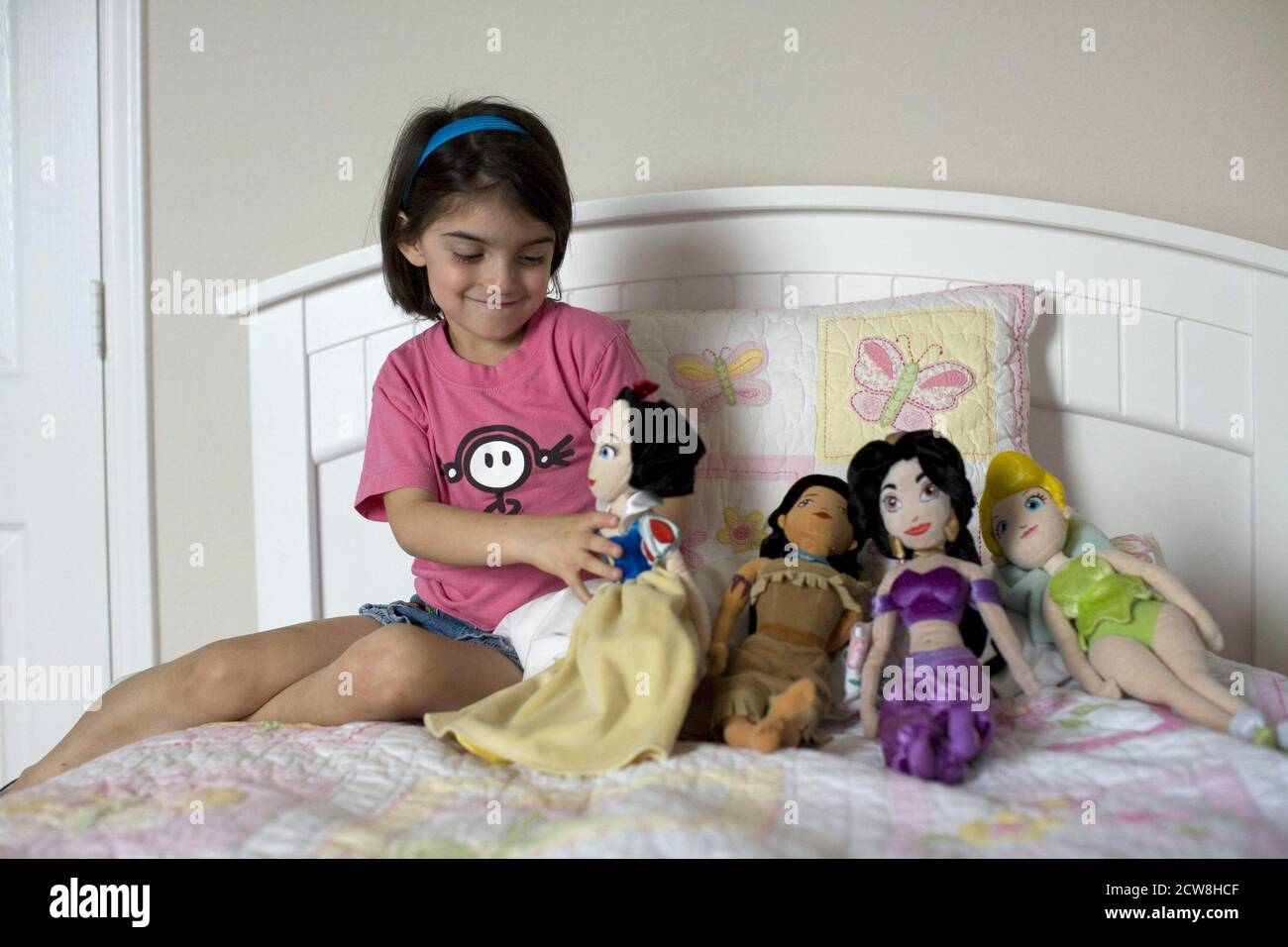 Hispanic 6 year old plays with dolls at home.  ©Bob Daemmrich Stock Photo