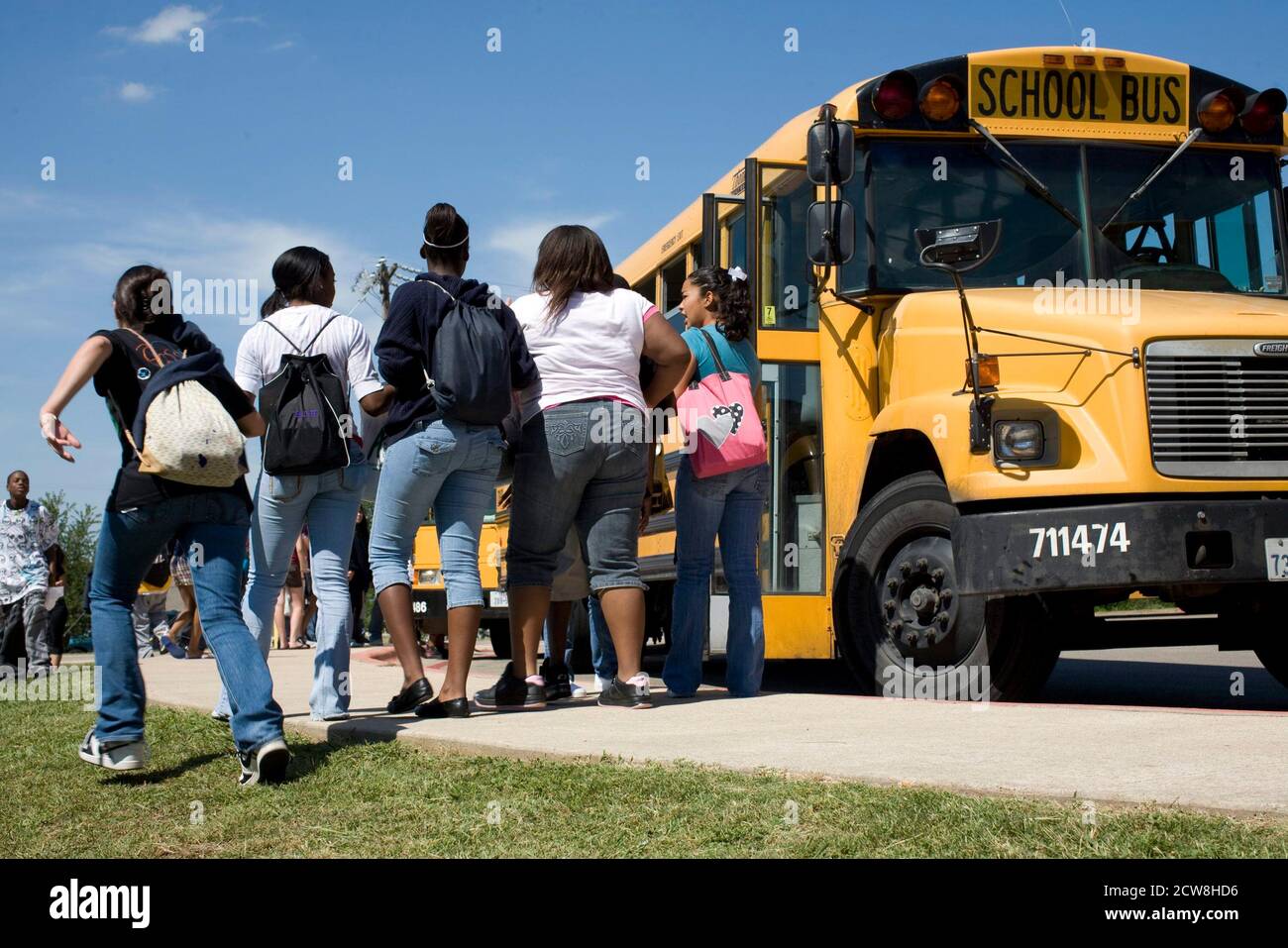 Pflugerville, TX  June 2, 2008: Middle school students leaving on buses at Park Crest Middle School in an Austin suburb.  ©Bob Daemmrich/ Stock Photo