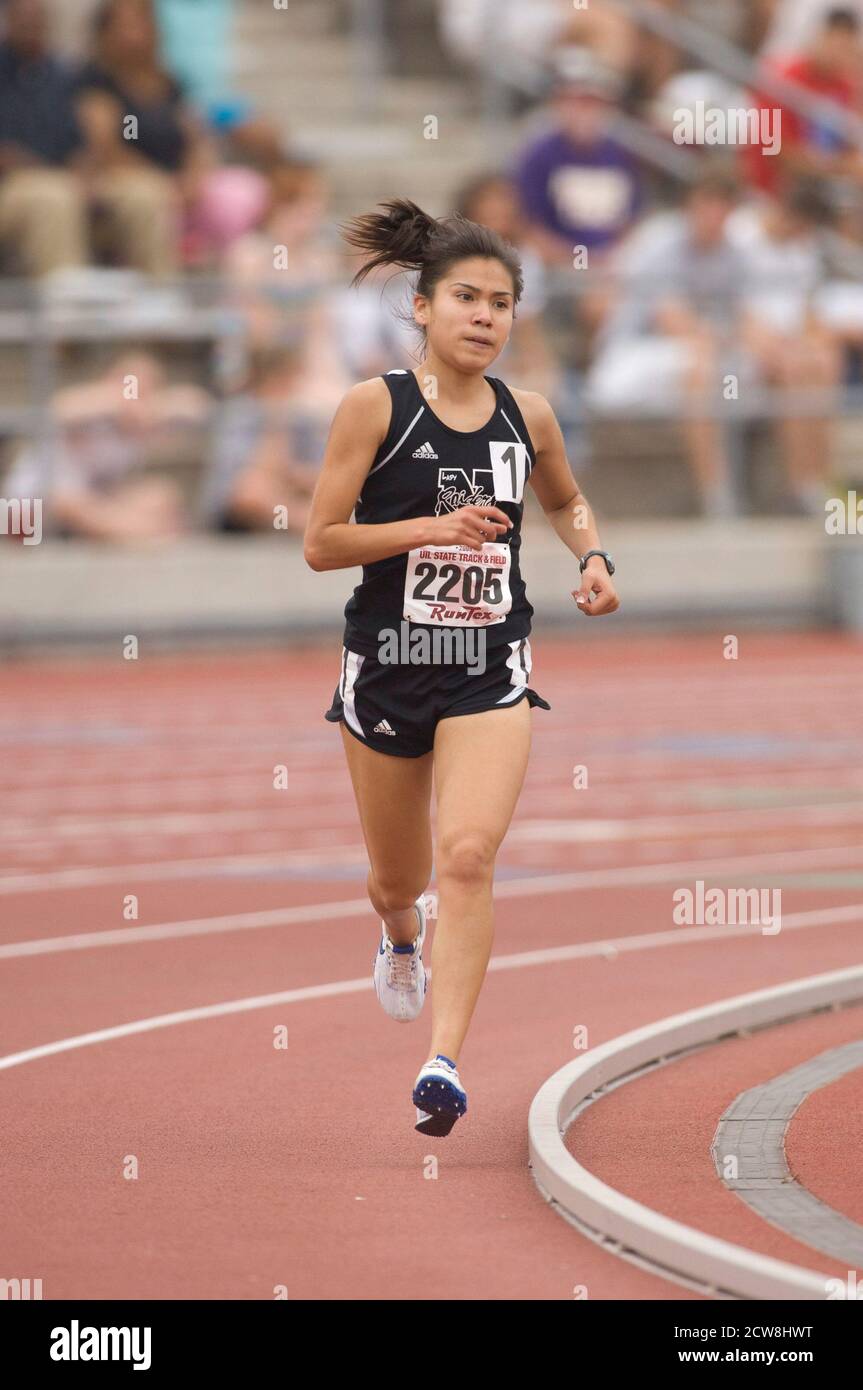 Austin, TX May 10, 2008: Hispanic girl rounds the corner during the 3,200-meter run at the Texas state UIL High School Track meet at the University of Texas at Austin.      ©Bob Daemmrich/ Stock Photo