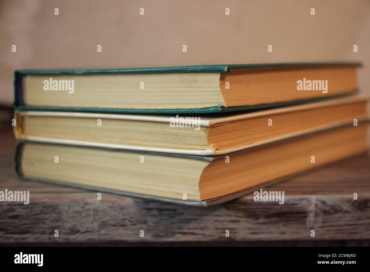 three old books in a library. Knowledge education concept Stock Photo