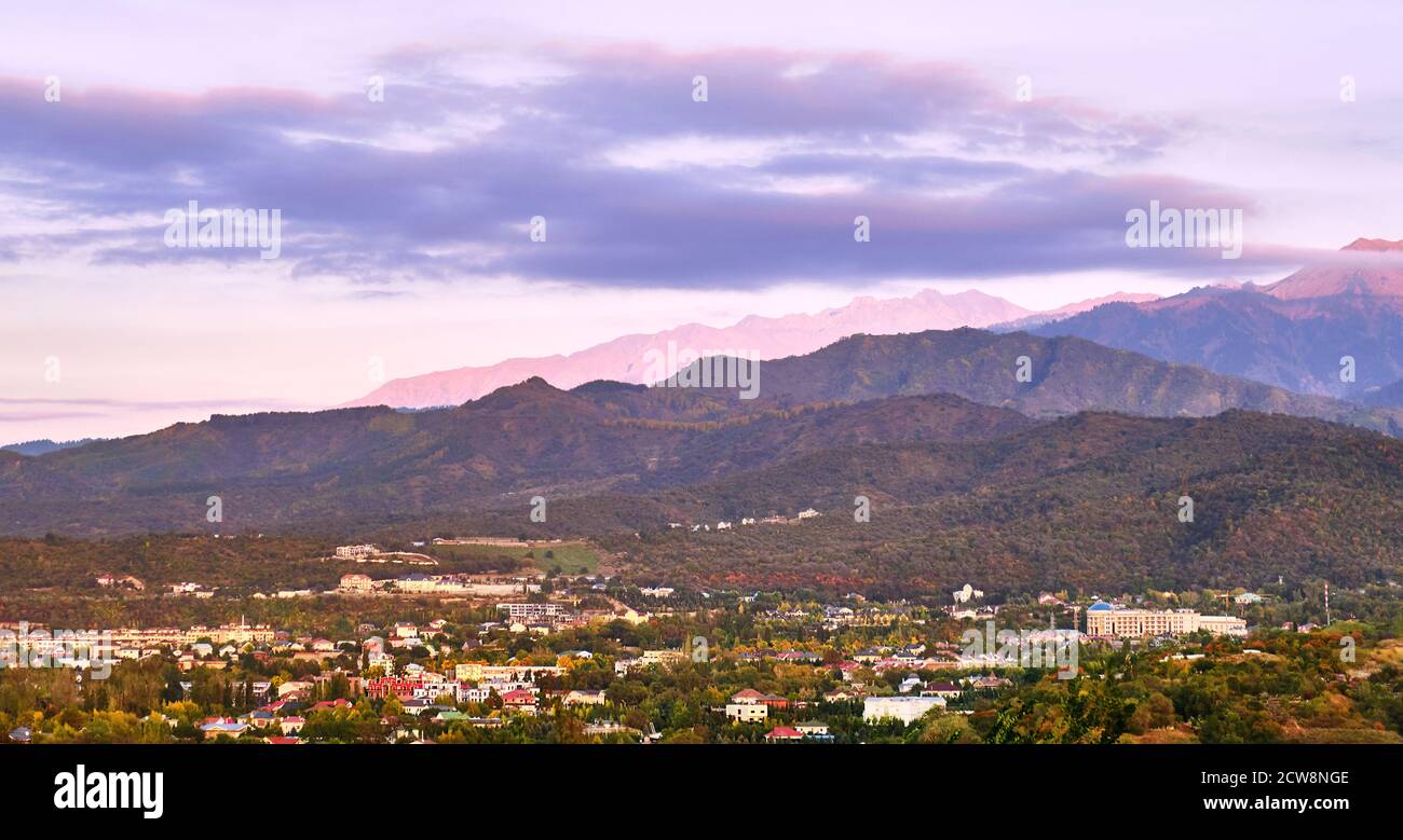 Houses of beautiful architecture in the foothills at sunset; outskirts