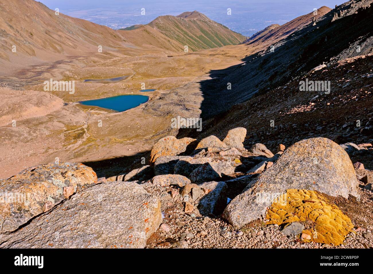 Fancy rocks overgrown with moss in a mountain valley with moraine lakes ...