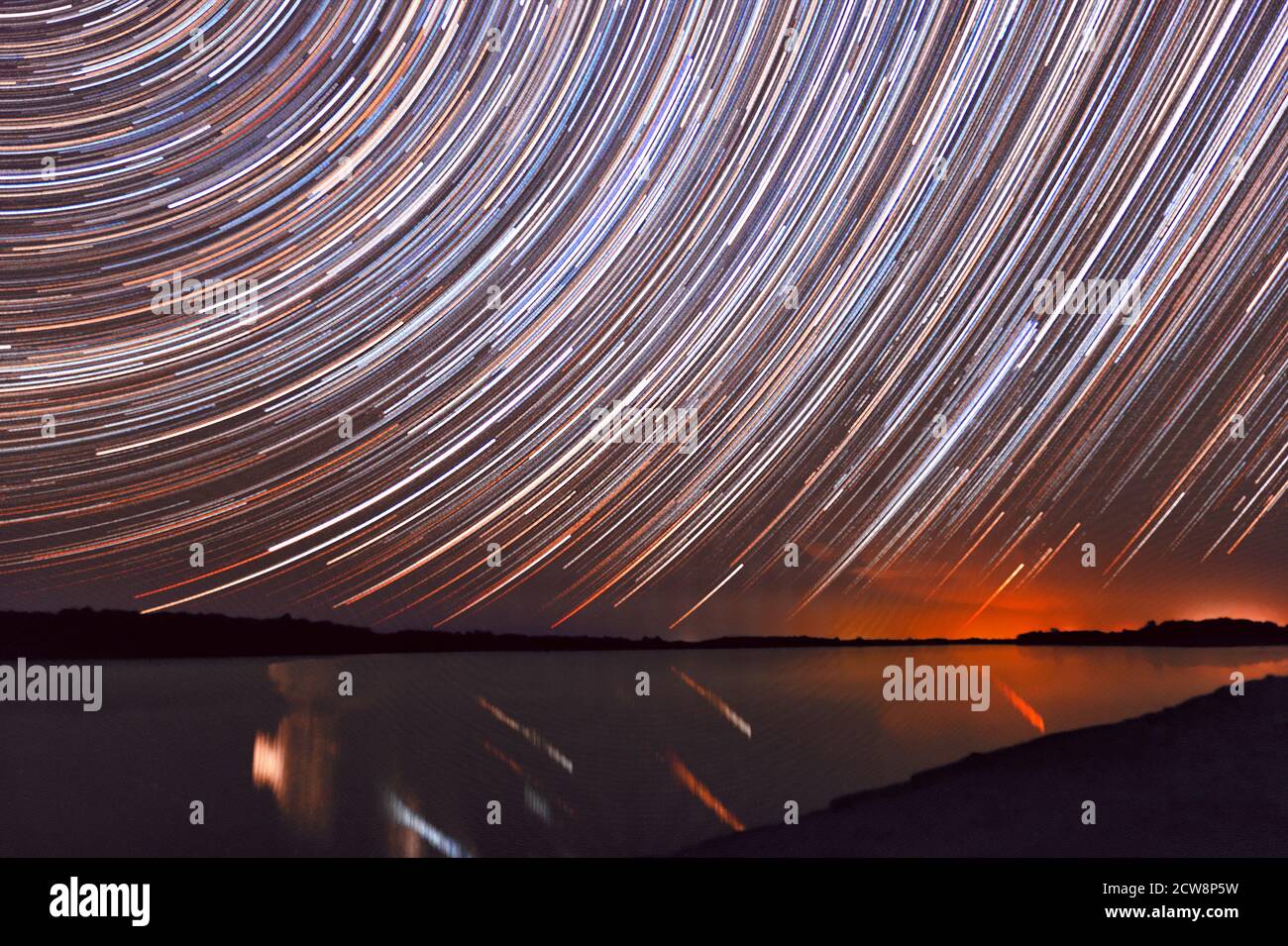 Magnificent view with star trails over the river just after sunset Stock Photo