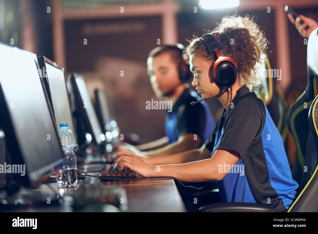 Team of professional teenage cyber sport gamers participating in eSports tournament, playing online video games Stock Photo