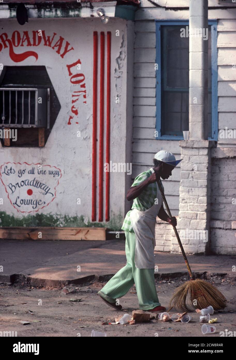 AFRICAN AMERICAN SWEEPING OUTSIDE CLUB, DOWNTOWN SAVANNAH, USA