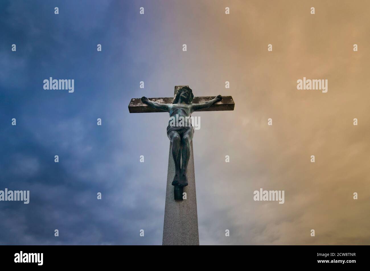 Jesus Christ on the cross against dramatic cloudy sky Stock Photo - Alamy