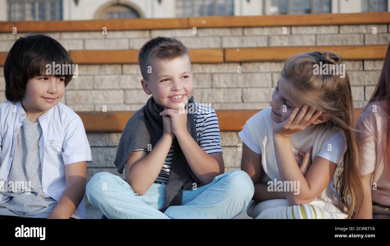 Cute little children sitting on a bench. Happy childhood. Stock Photo