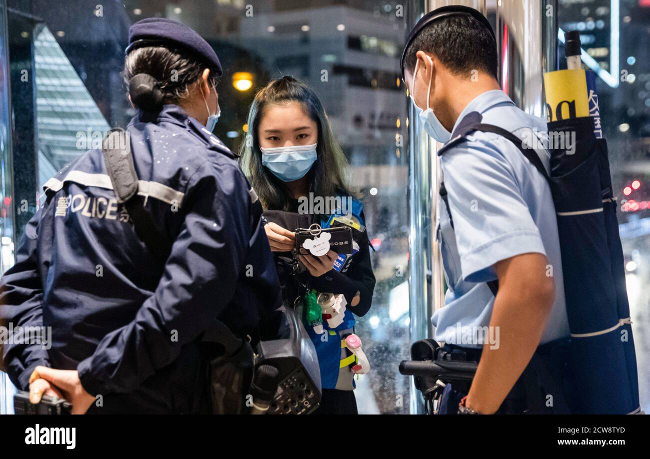 A medical staff shows police her identification during the protest to commemorate the 6th anniversary of Umbrella movement.Dozens of pro-democracy protesters gathered at the Pacific Place shopping mall in Hong Kong to mark the 6th anniversary of Umbrella movement where Hong Kongers took to the street and occupied the major roads in the city to demand for universal suffrage. Stock Photo
