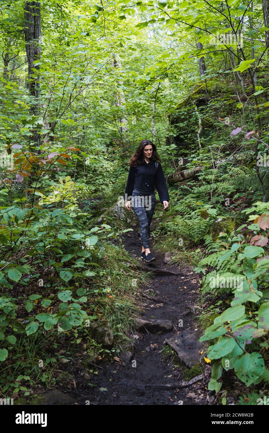 A young woman hiking on a trail in the Adirondacks Stock Photo - Alamy