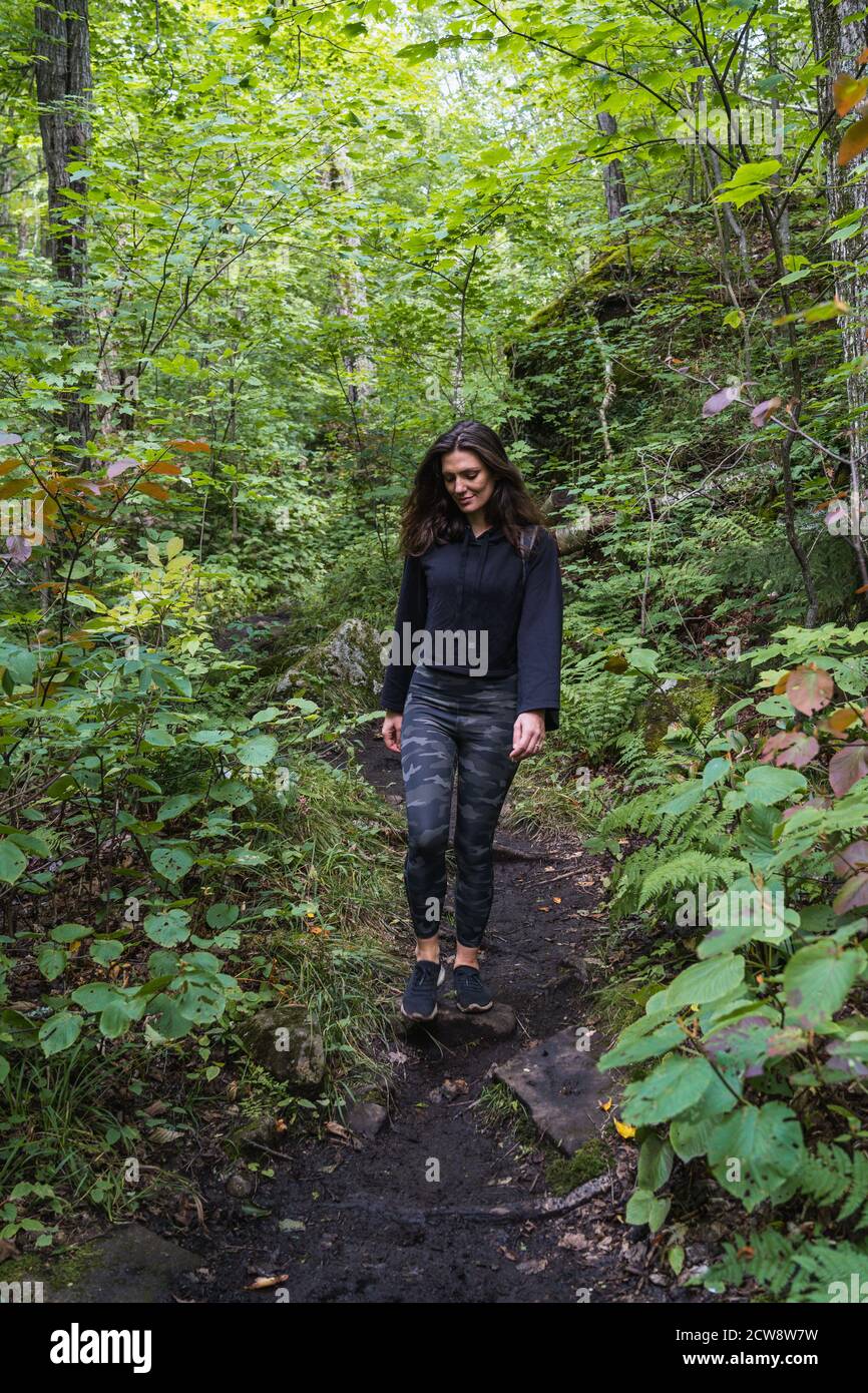 A young woman hiking on a trail in the Adirondacks Stock Photo - Alamy