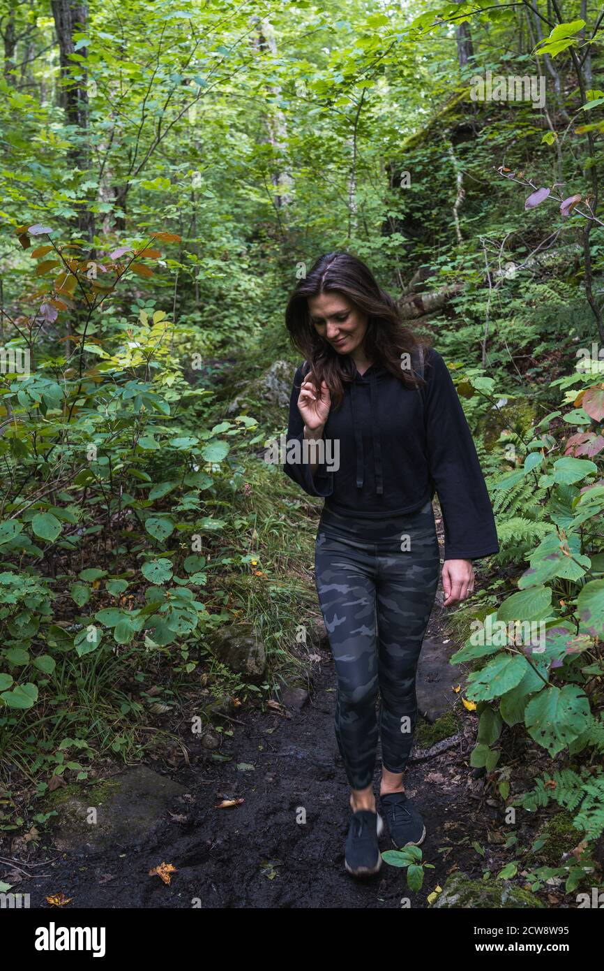 A young woman hiking on a trail in the Adirondacks Stock Photo - Alamy