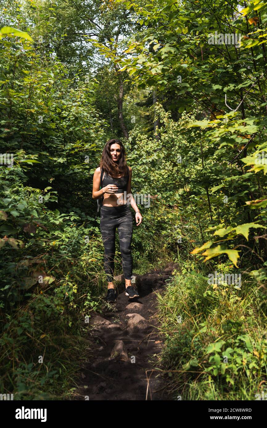 A young woman hiking on a trail in the Adirondacks Stock Photo - Alamy
