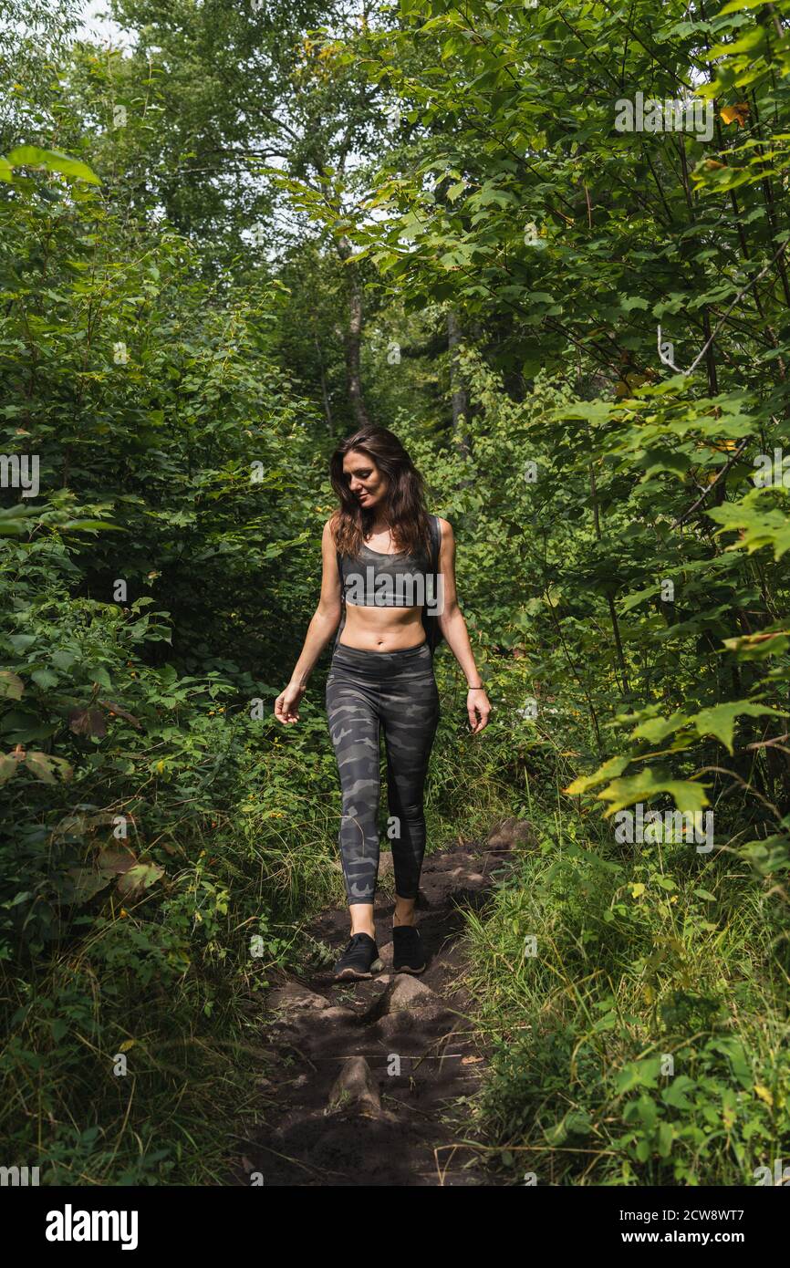 A young woman hiking on a trail in the Adirondacks Stock Photo - Alamy
